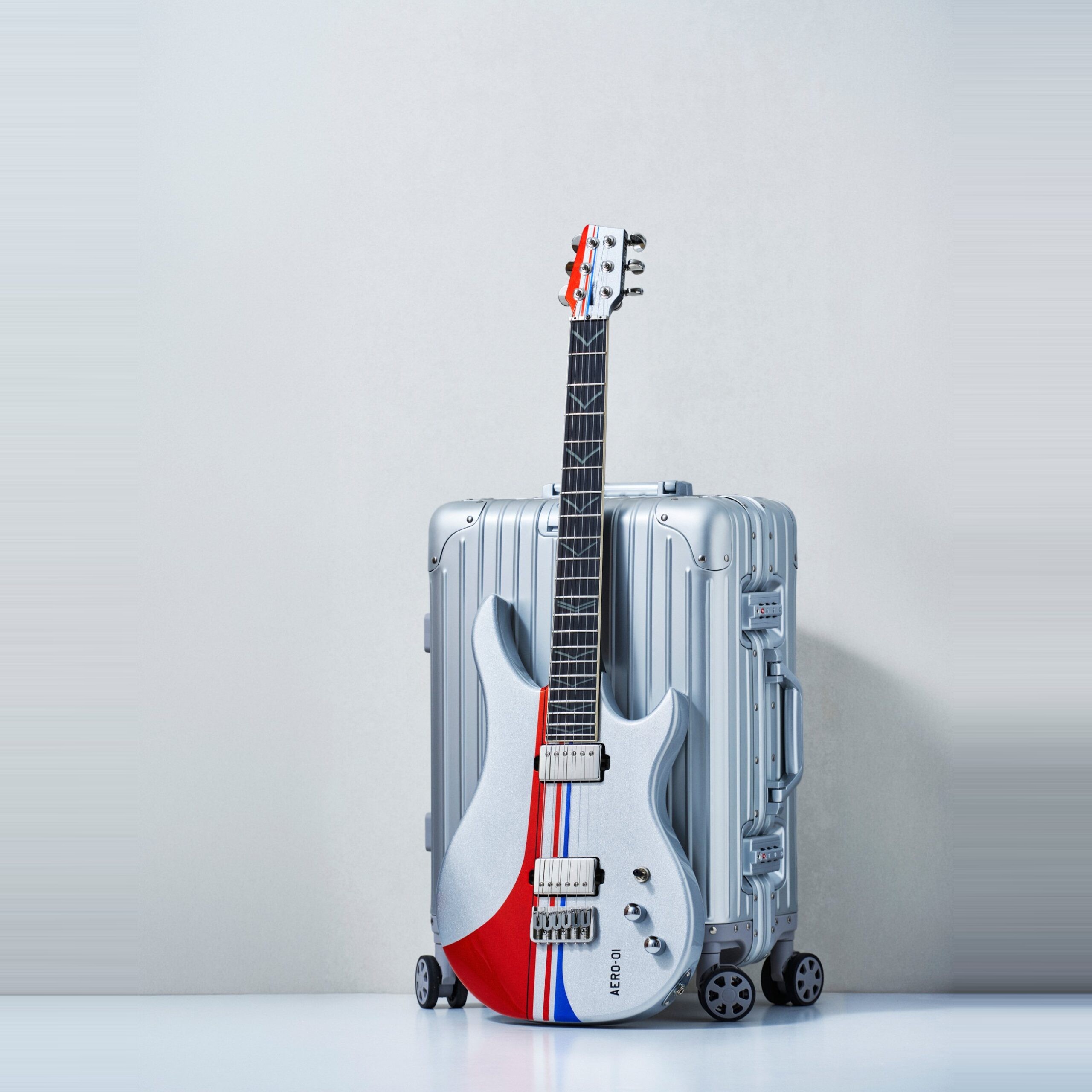 AERO 01 Flightcaster Series travel guitar with its cabin suitcase